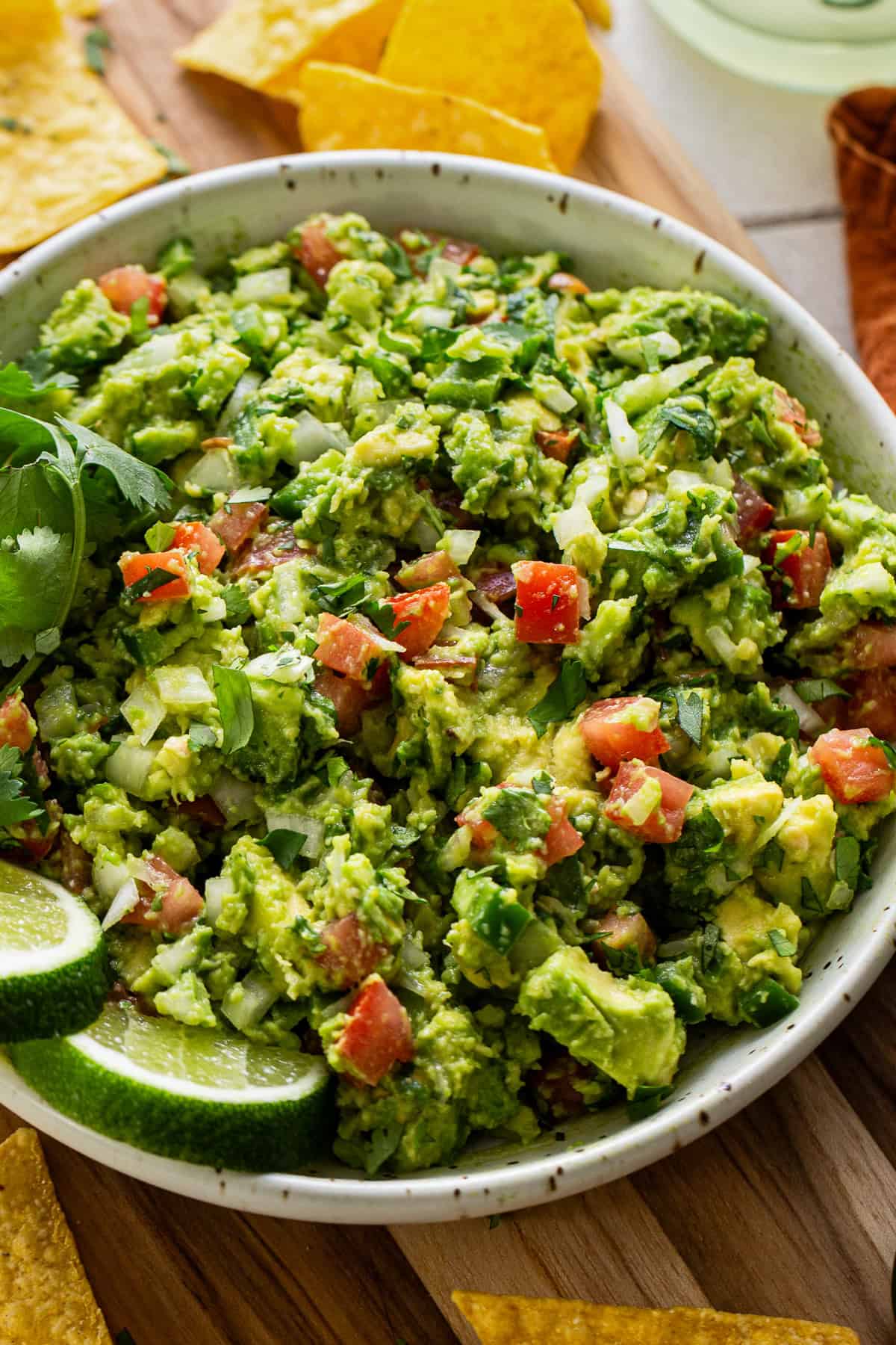 Guacamole in a bowl served with tortilla chips.