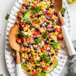 Mexican Quinoa Salad topped with cilantro and served with lime wedges.