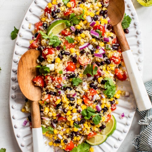 Mexican Quinoa Salad topped with cilantro and served with lime wedges.