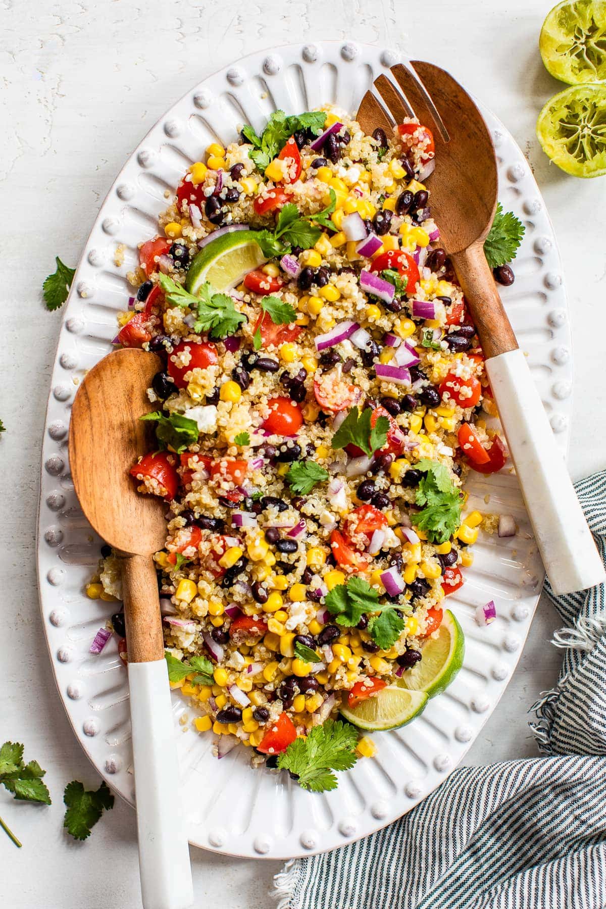 Mexican Quinoa Salad topped with cilantro and served with lime wedges.