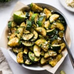 Roasted Mexican Zucchini in a bowl topped with cotija cheese, lime juice, and cilantro.