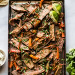 Sheet pan steak fajitas topped with cilantro.