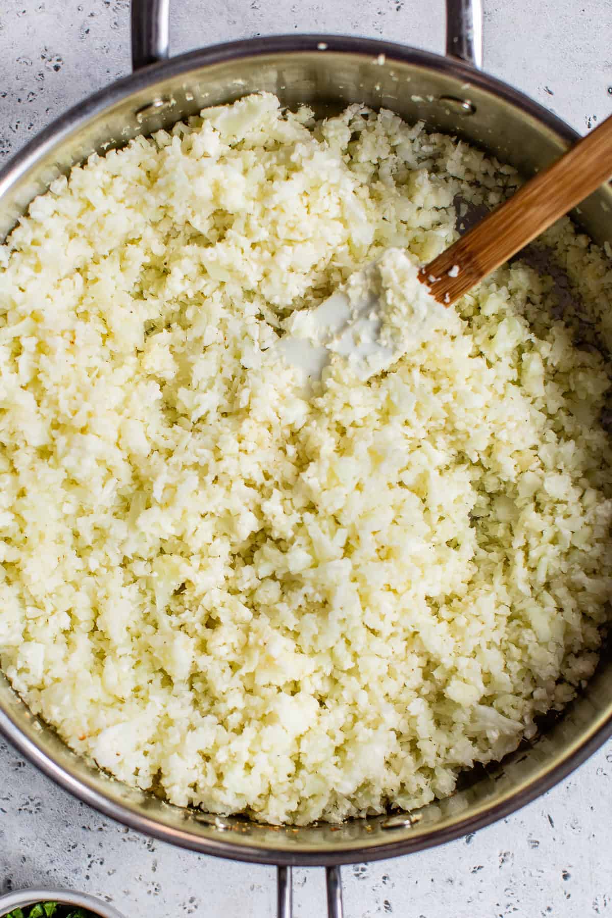Riced cauliflower sauteed in a skillet.