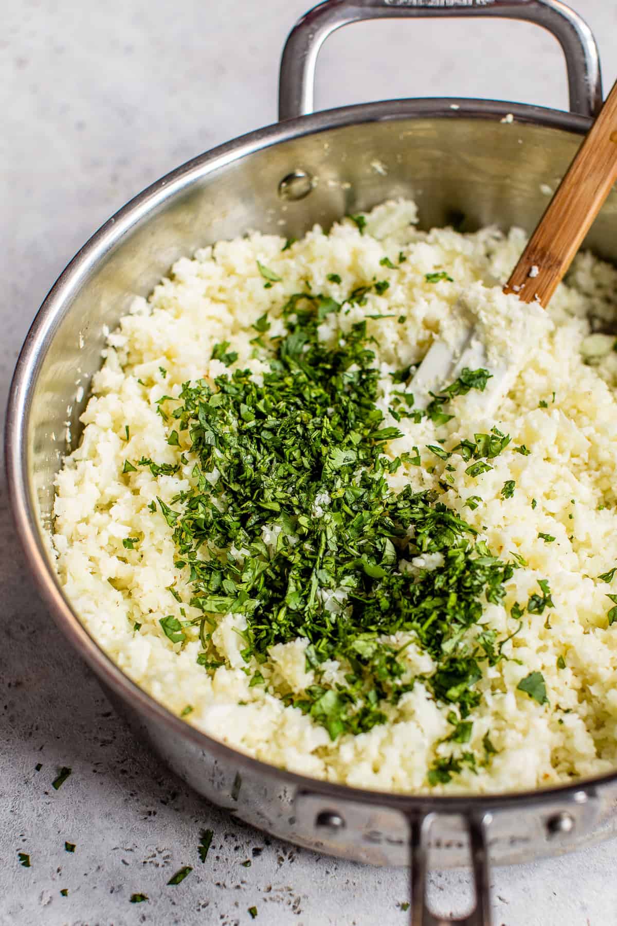 Chopped cilantro and lime juice on top of the cauli rice before being mixed in.