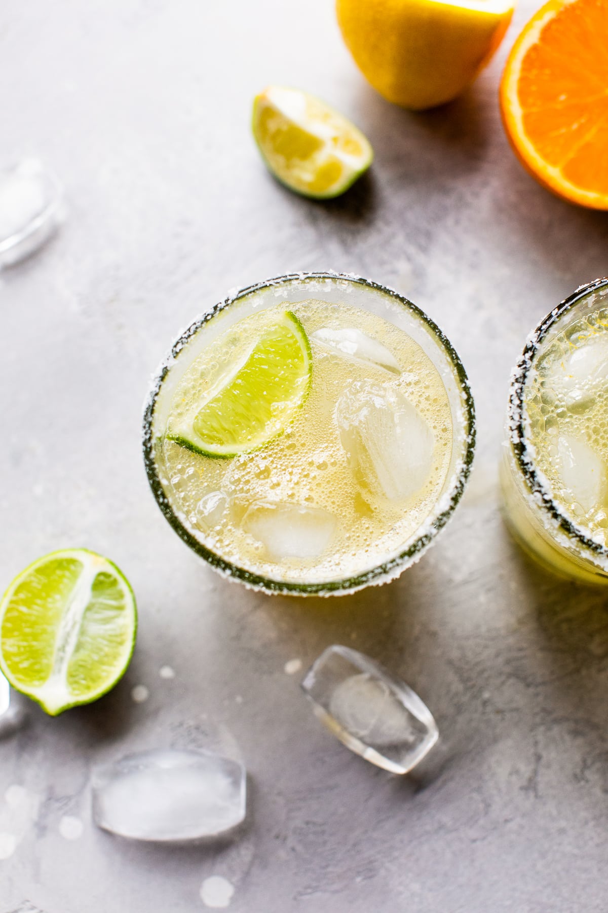 Virgin margarita mocktail on the rocks with a lime wedge.