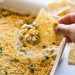 Chile relleno dip on a tortilla chip.