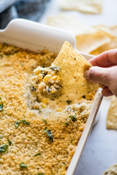 Chile relleno dip on a tortilla chip.