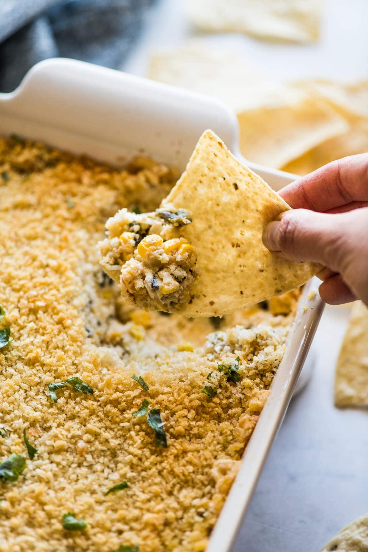 Chile relleno dip on a tortilla chip.