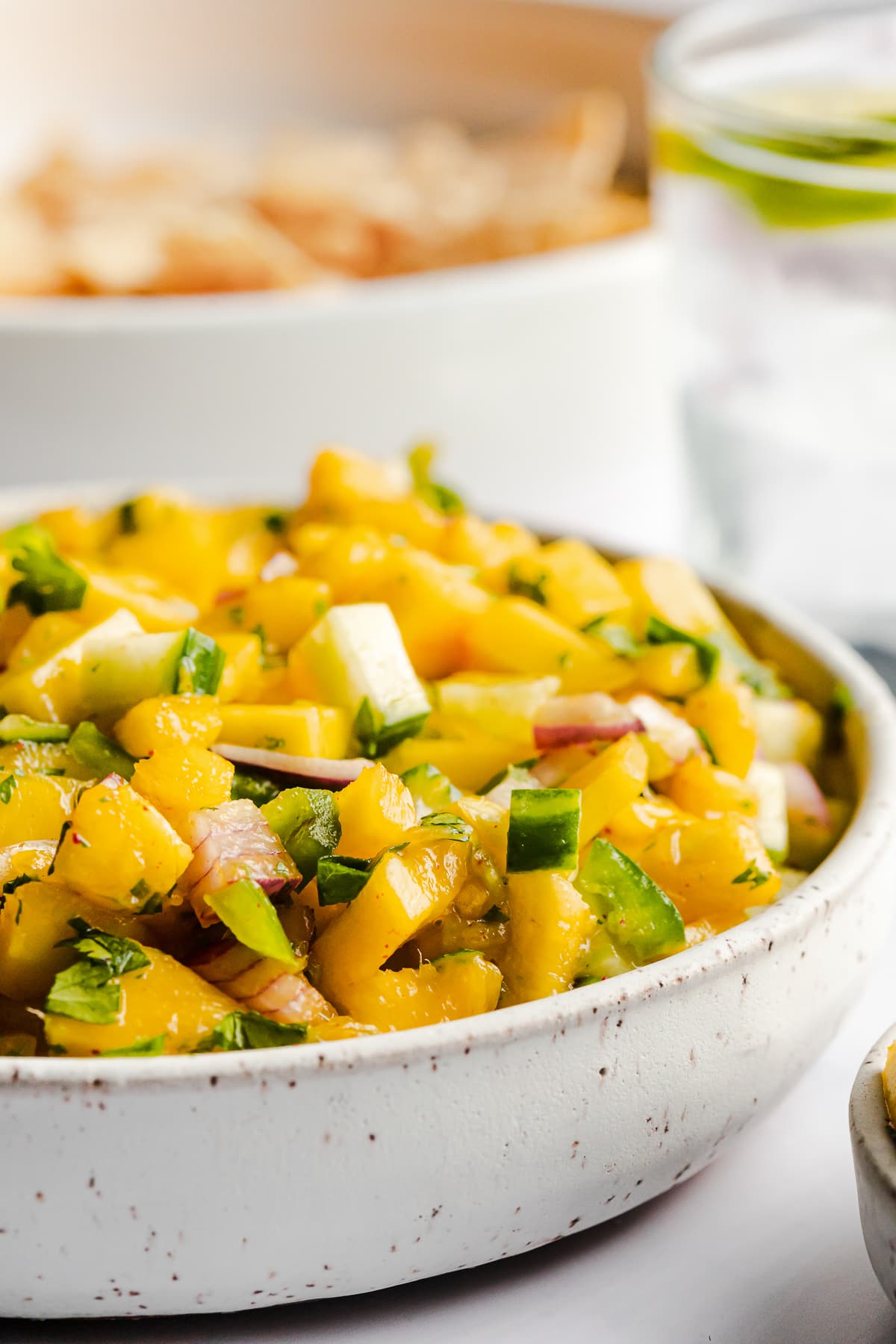 Mango salsa topped with chopped cilantro ready to be served.