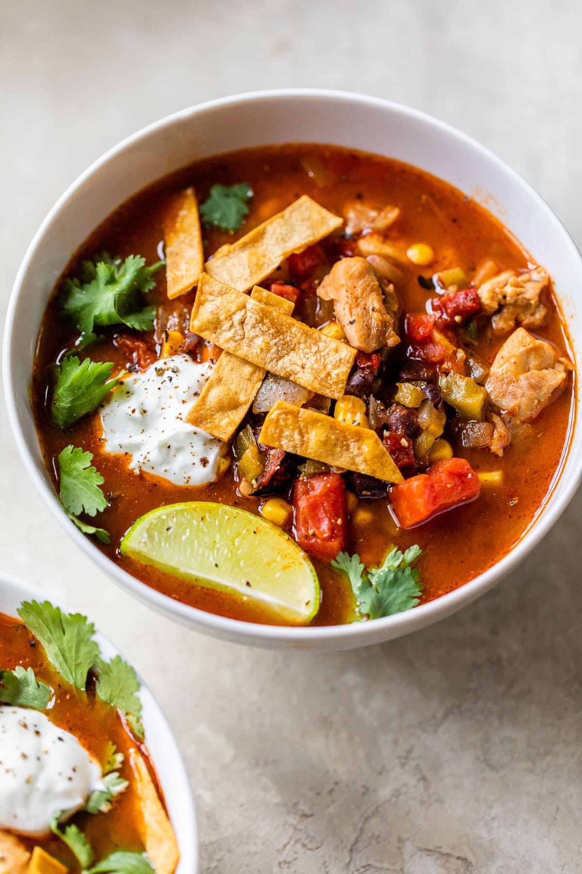 Healthy and delicious Southwest Chicken Soup topped with tortilla strips.