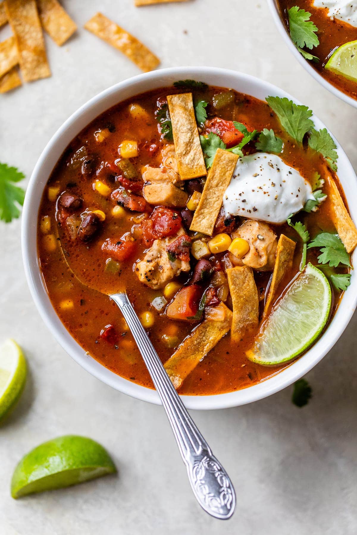 Southwest Chicken Soup ready to be eaten in a bowl served with all the fixings.