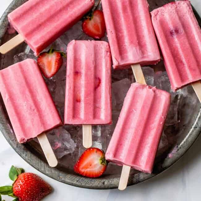Strawberries and cream popsicles ready to be eaten.