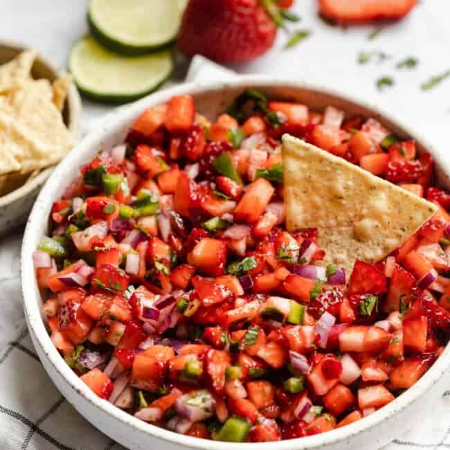 Strawberry Salsa in a bowl next to tortilla chips.