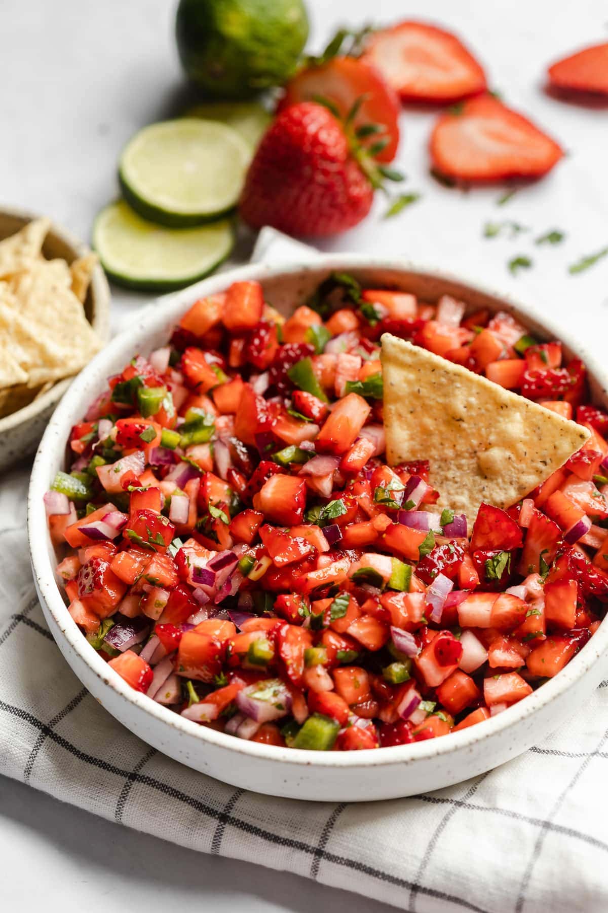 Strawberry Salsa in a bowl next to tortilla chips.