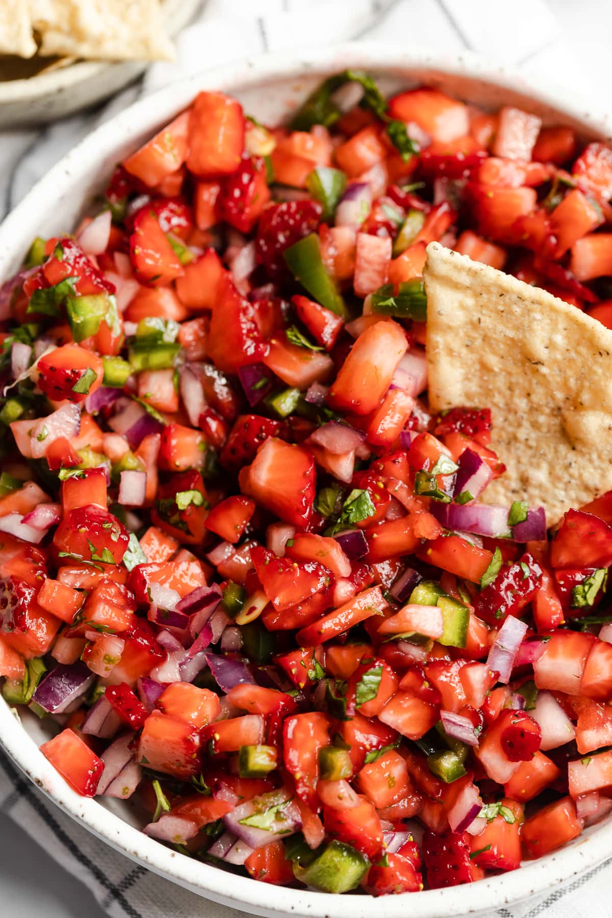 Strawberry salsa topped with chopped cilantro.