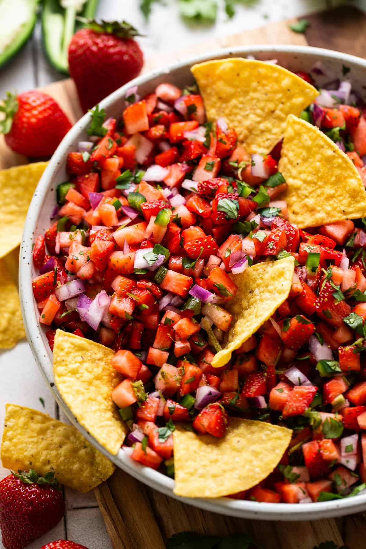 Strawberry salsa in a bowl with tortilla chips.