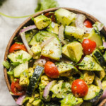 A bowl of avocado salad with cucumbers.