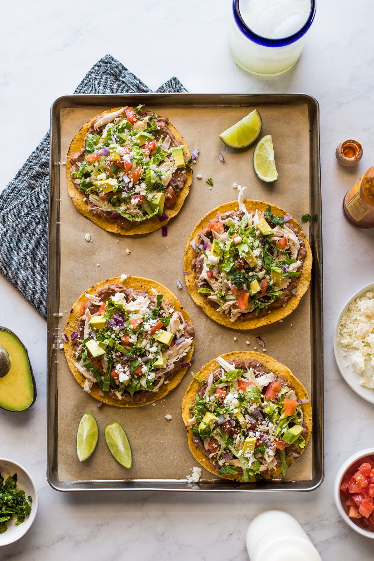Chicken tostadas made with refried beans, shredded chicken, and lots of toppings.