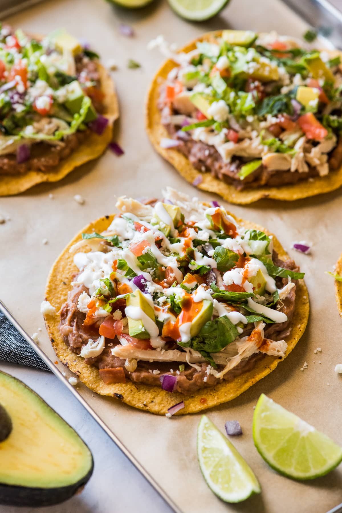 Chicken tostadas topped with sour cream and salsa.