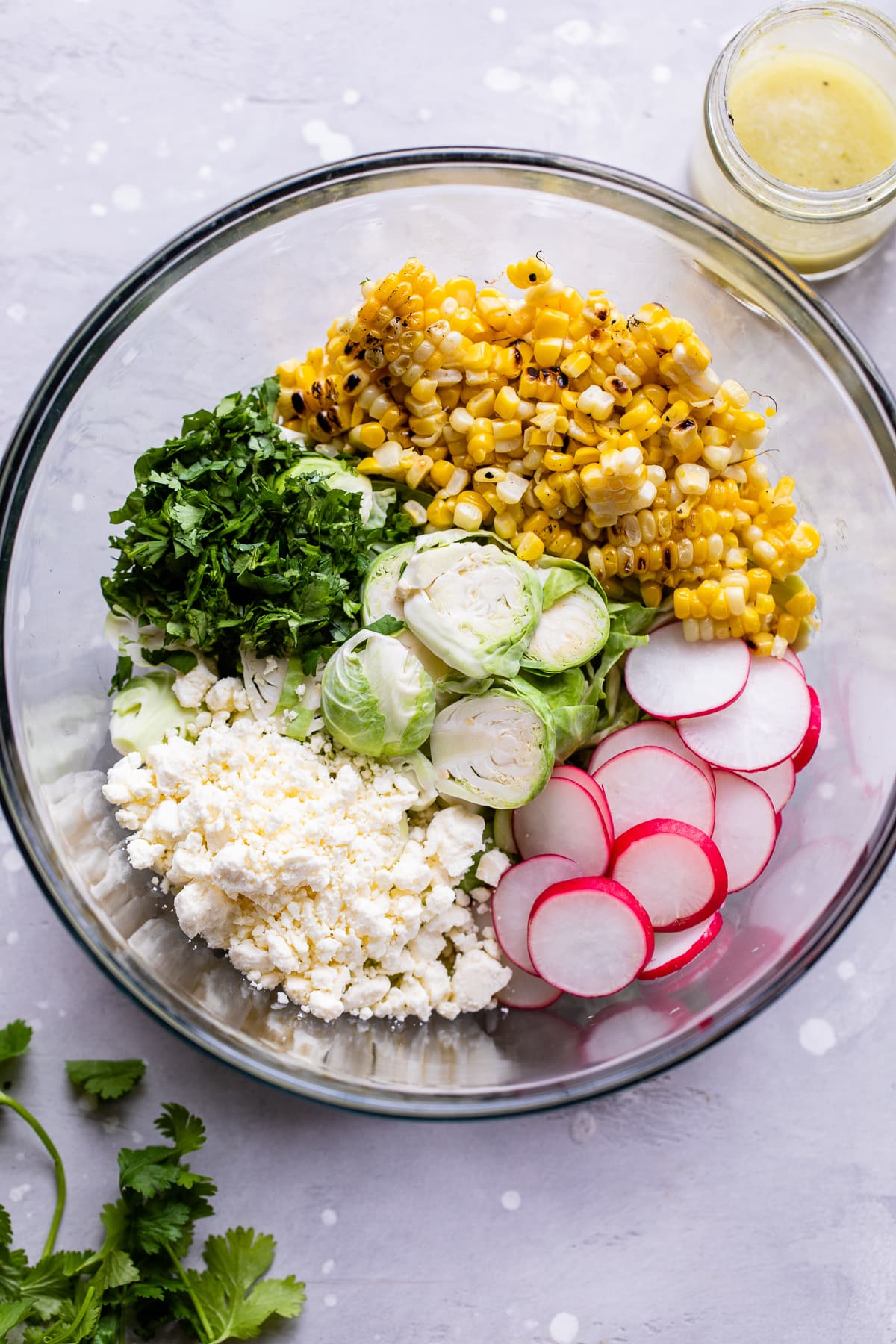 Ingredients for Mexican Brussels Sprouts Salad in a large bowl.