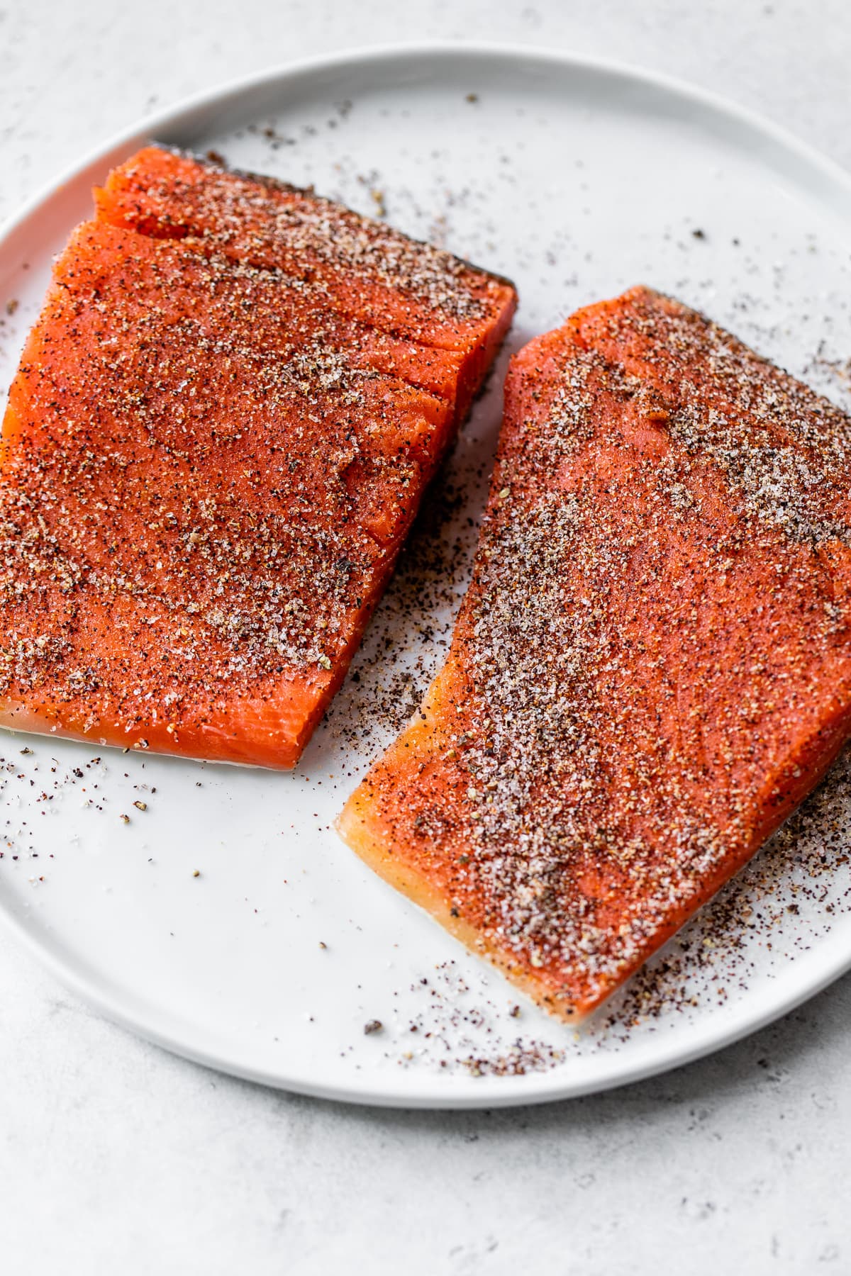 Salmon filets seasoned with a dry rub.