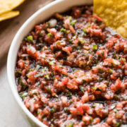 This homemade fresh salsa recipe is made with only 6 ingredients - tomatoes, onions, cilantro, garlic, jalapeño, and lime juice. Ready to eat in only 5 minutes!