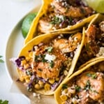 Shrimp tacos topped with cotija cheese and cilantro.