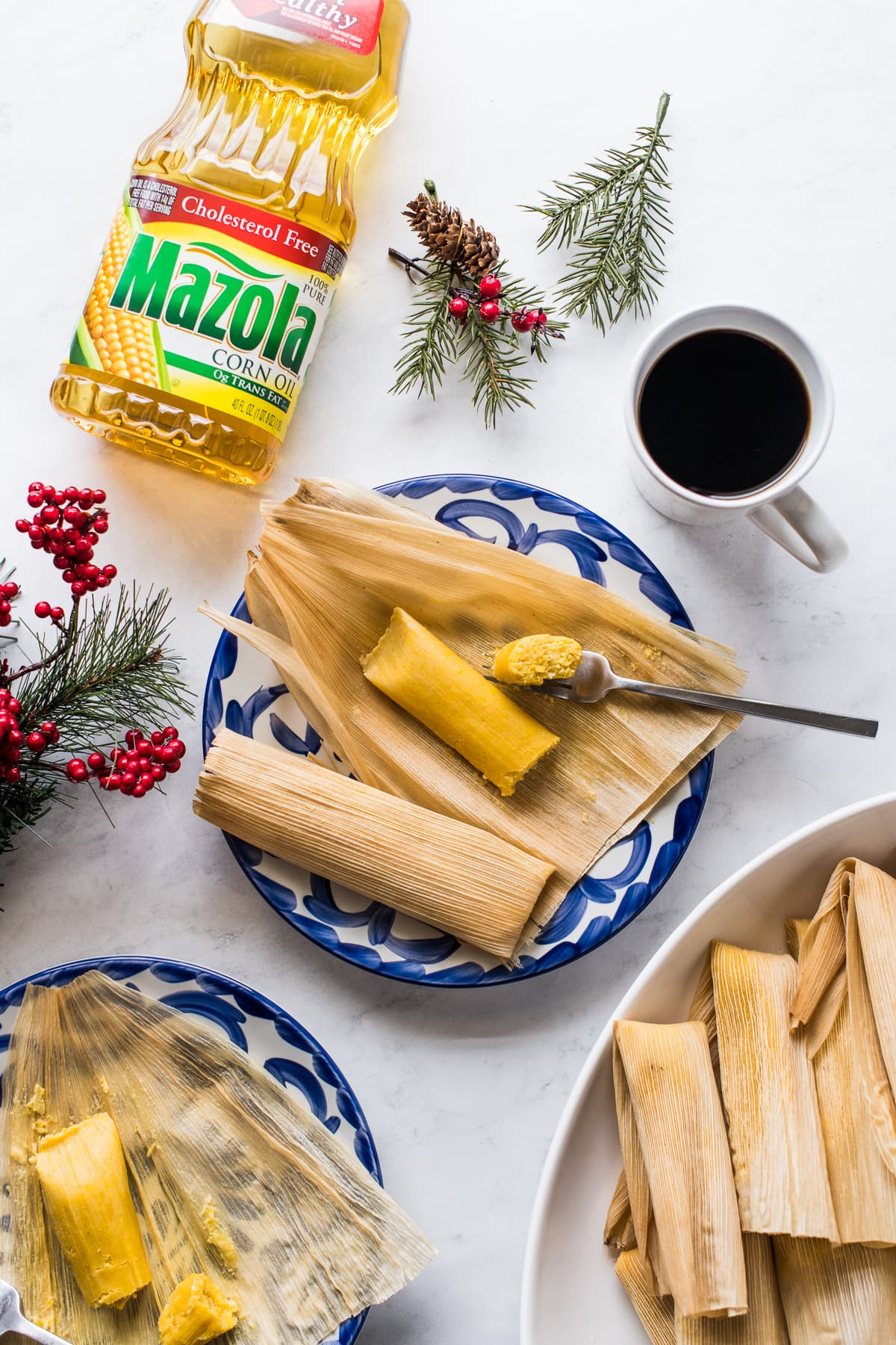 Tamales de Elote (or Sweet Corn Tamales) on two plates ready to be eaten.