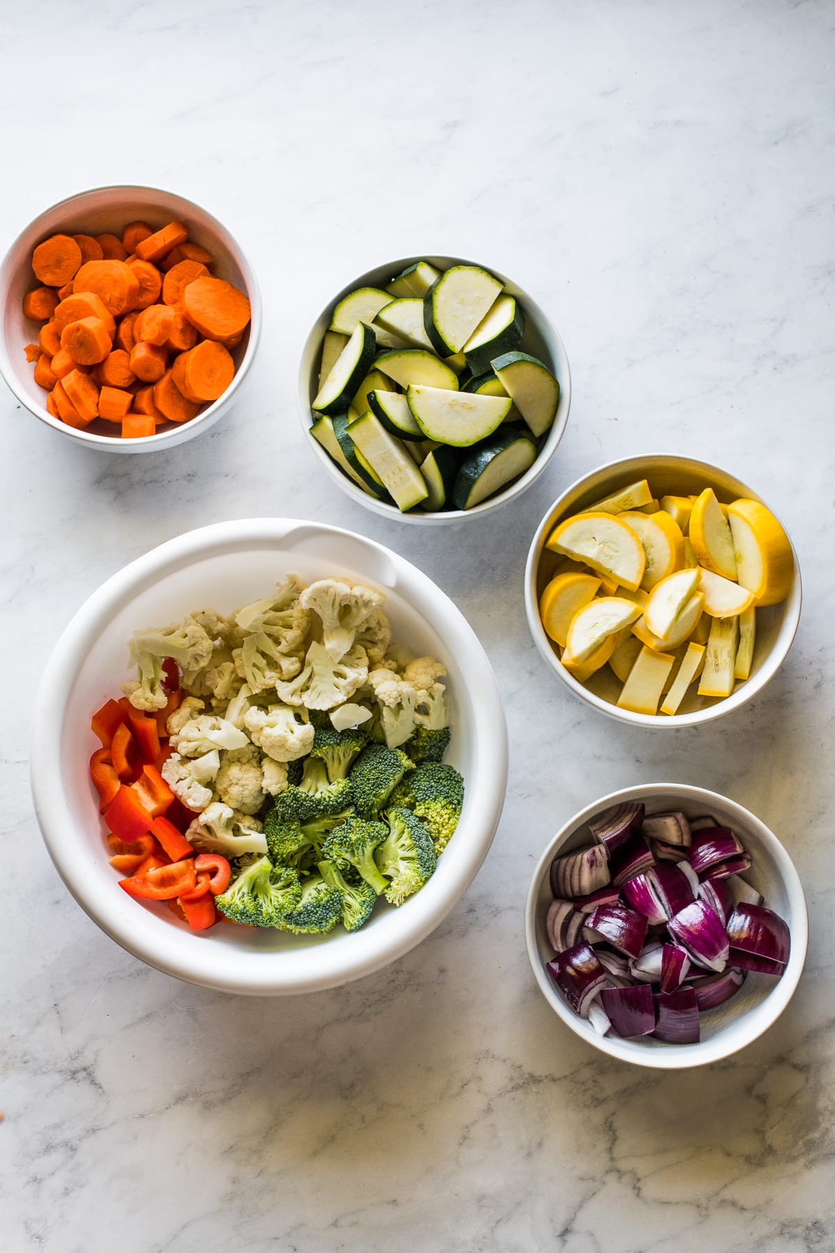Diced vegetables in bowls ready to be roasted.