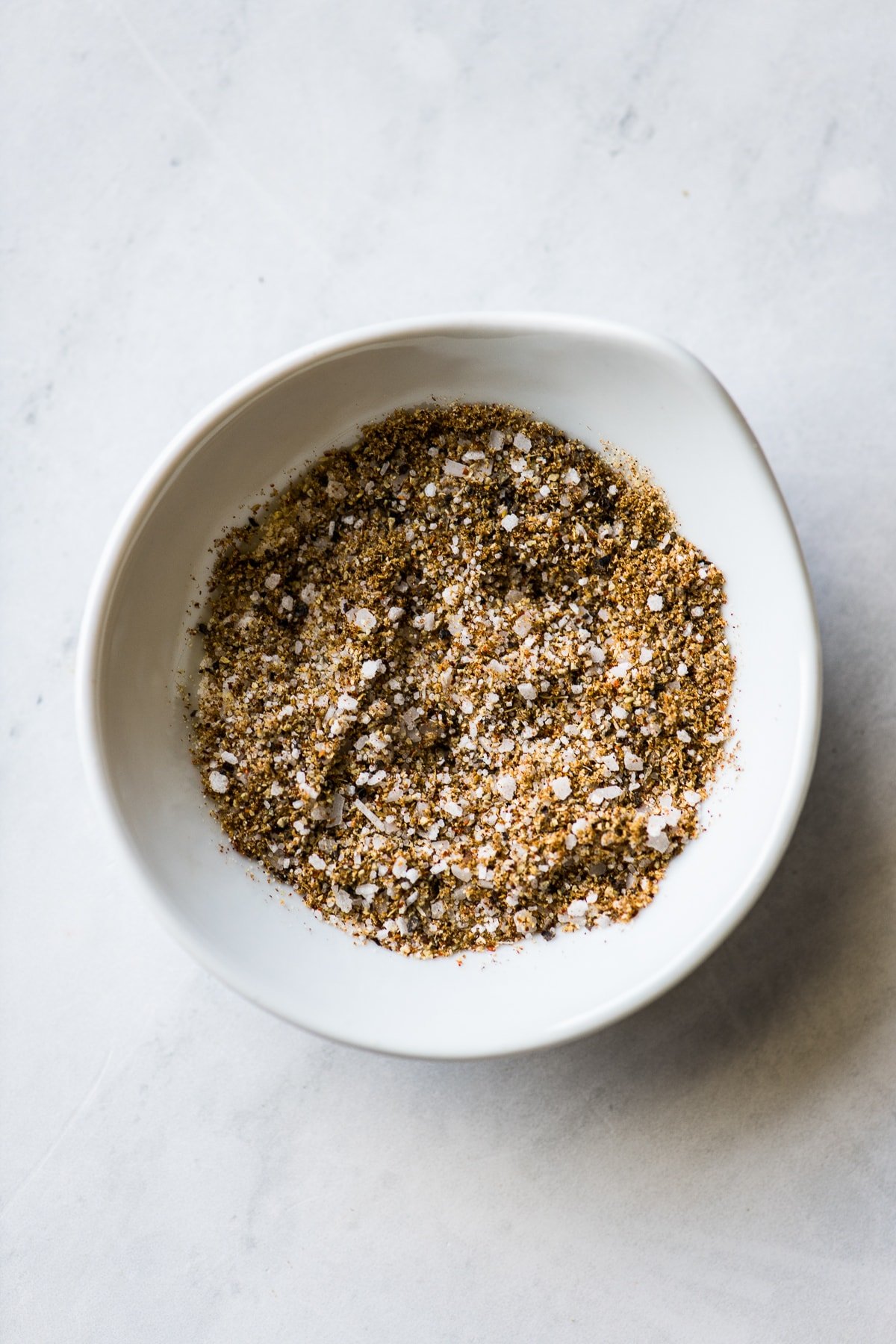 A bowl of seasonings and spices for roasted vegetables.