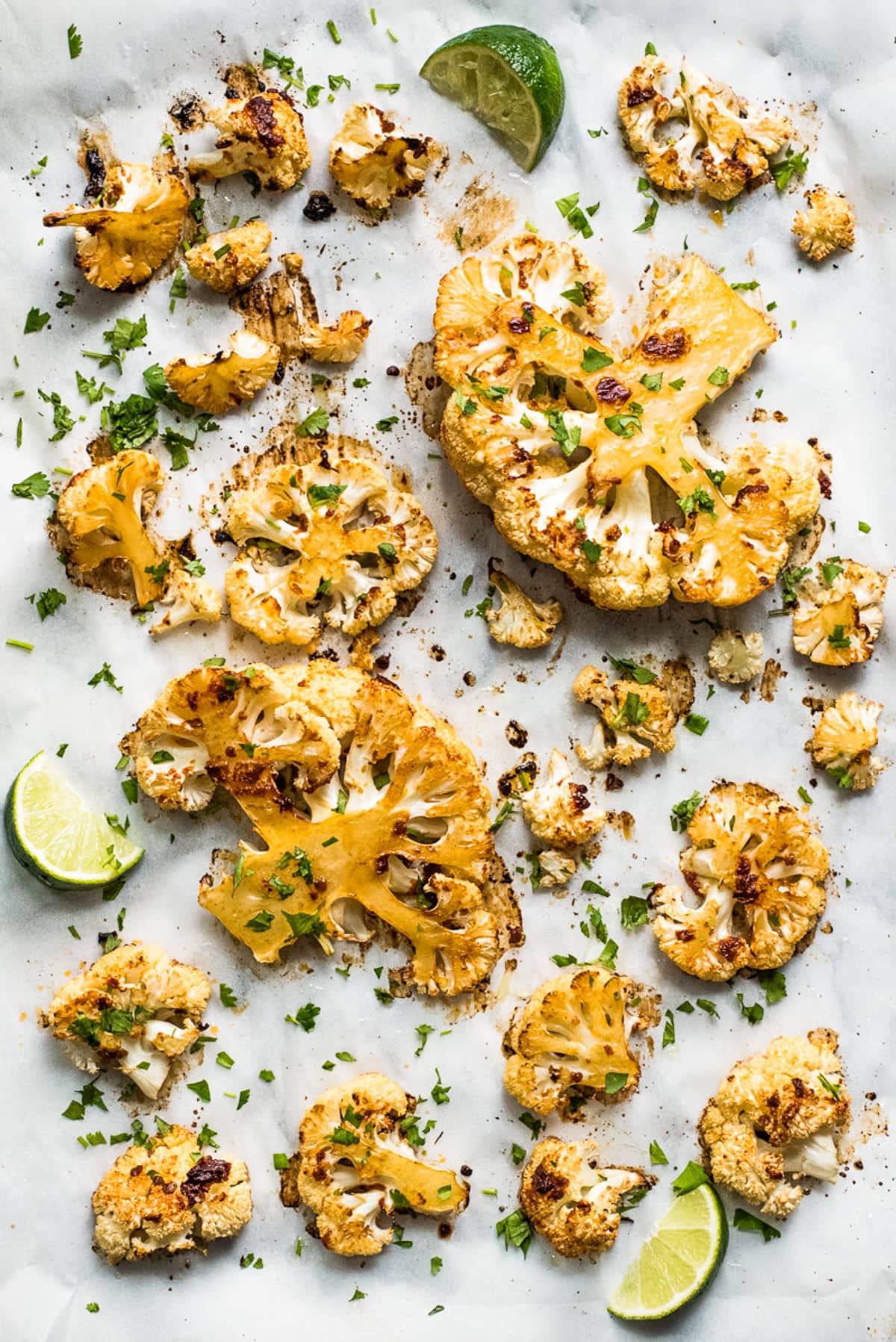 Spicy roasted cauliflower on parchment paper.
