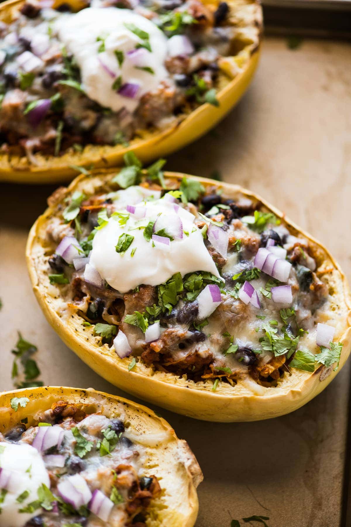 Stuffed spaghetti squash filled with chicken, beans, peppers, and onions.