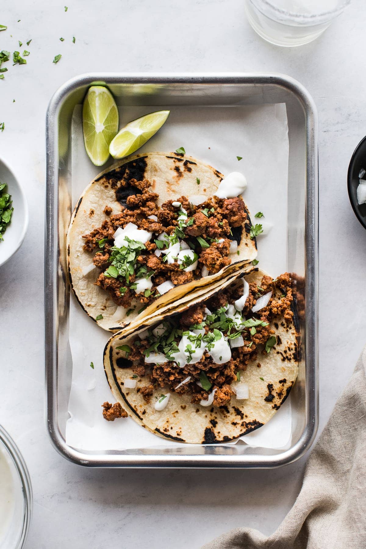 Chorizo tacos topped with lime crema and cilantro.