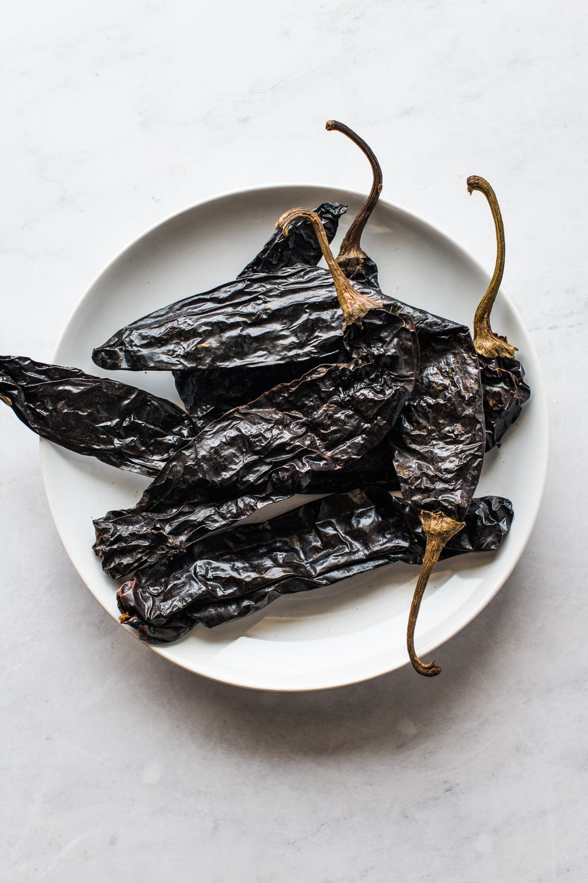 Pasilla peppers (chile pasilla) on a white plate