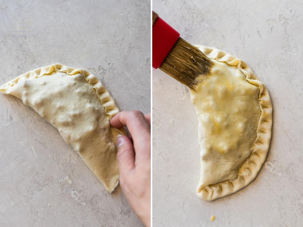 Beef empanadas being crimped together.