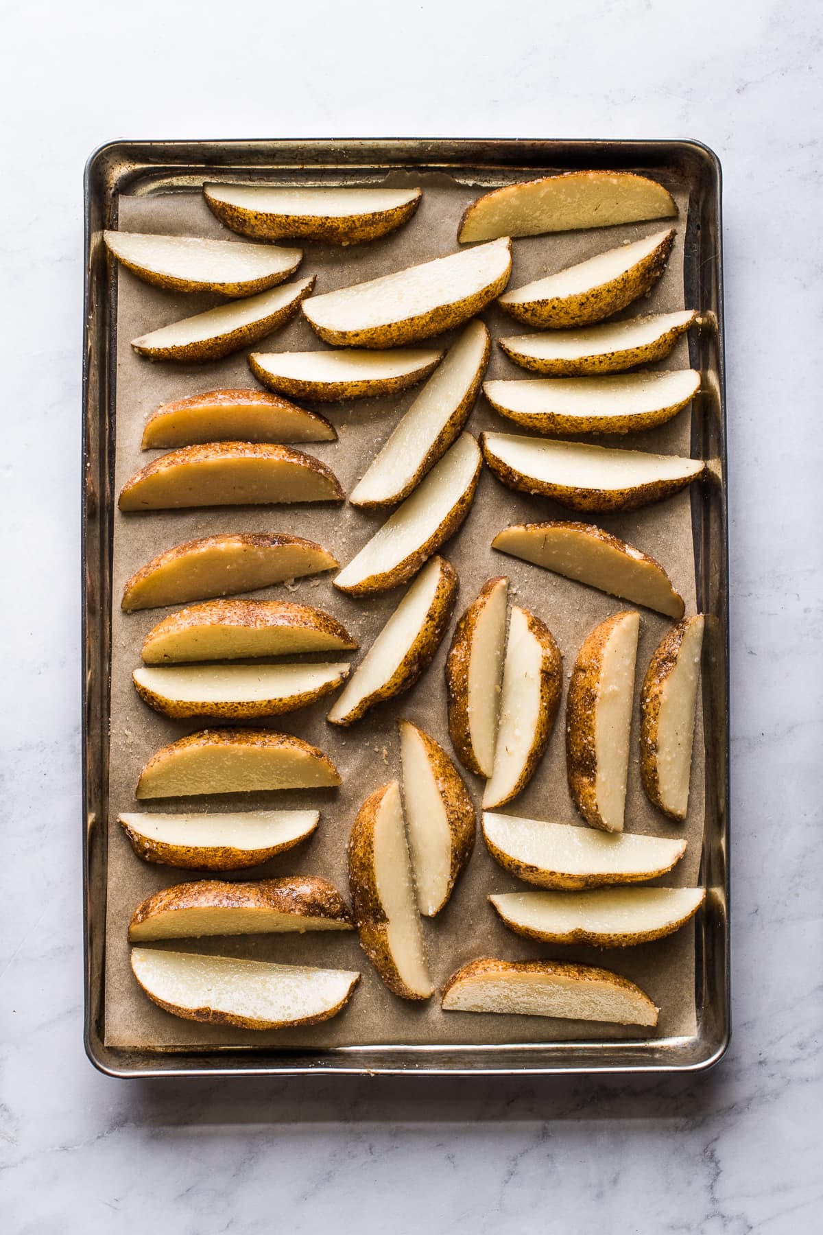 Potato wedges on a baking sheet.