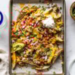 Loaded baked potato wedges made from potato wedges covered in melted cheese.