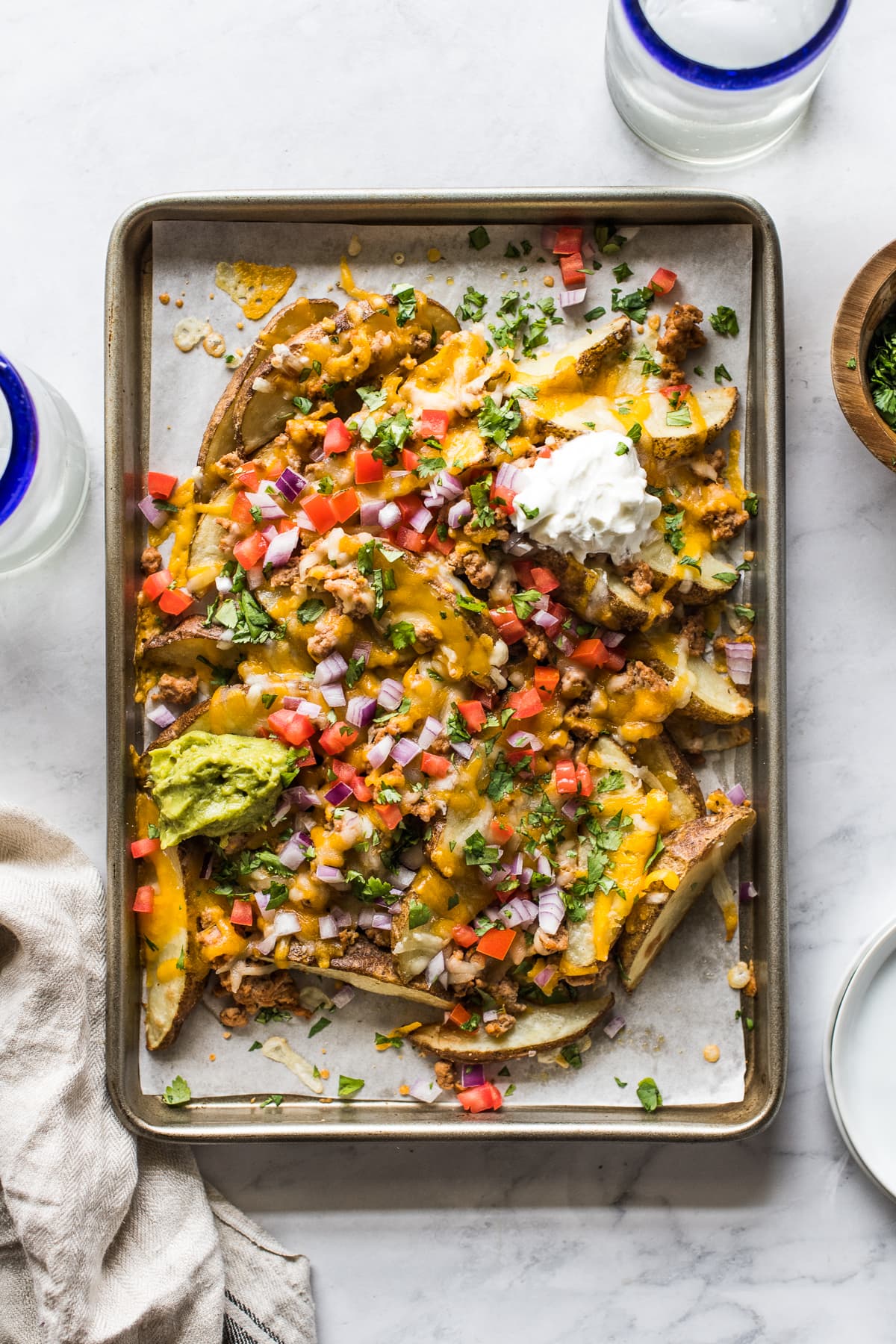 Loaded baked potato wedges made from potato wedges covered in melted cheese.