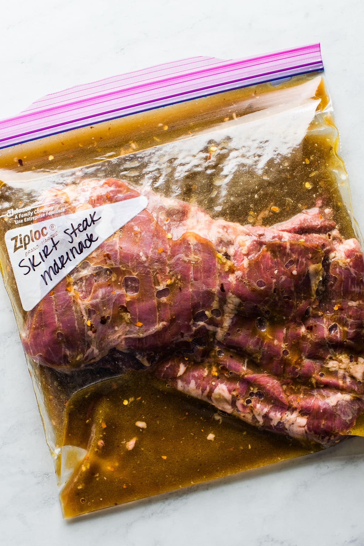 Skirt steak marinade in a plastic ziploc bag ready to go in the fridge.