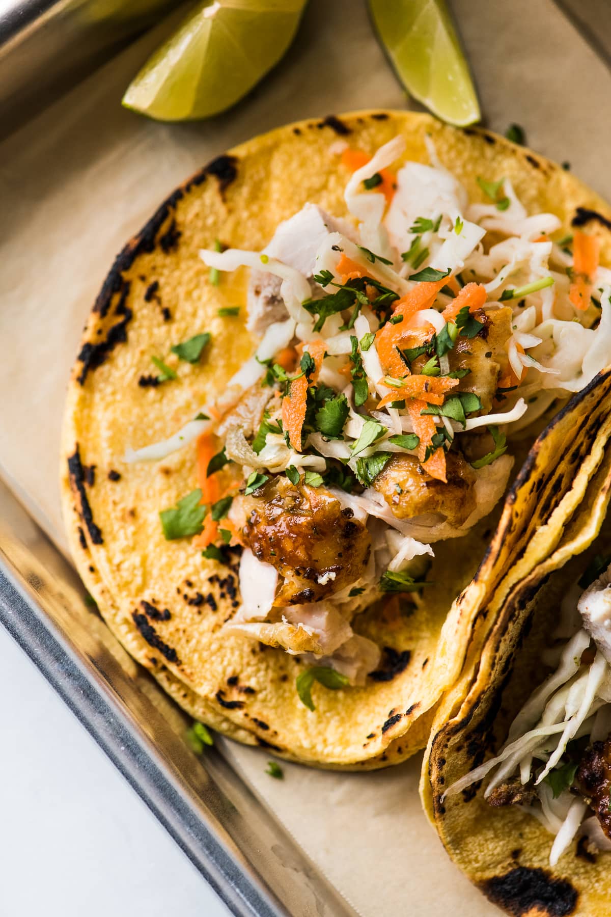 Beer can chicken tacos topped with shredded cabbage slaw