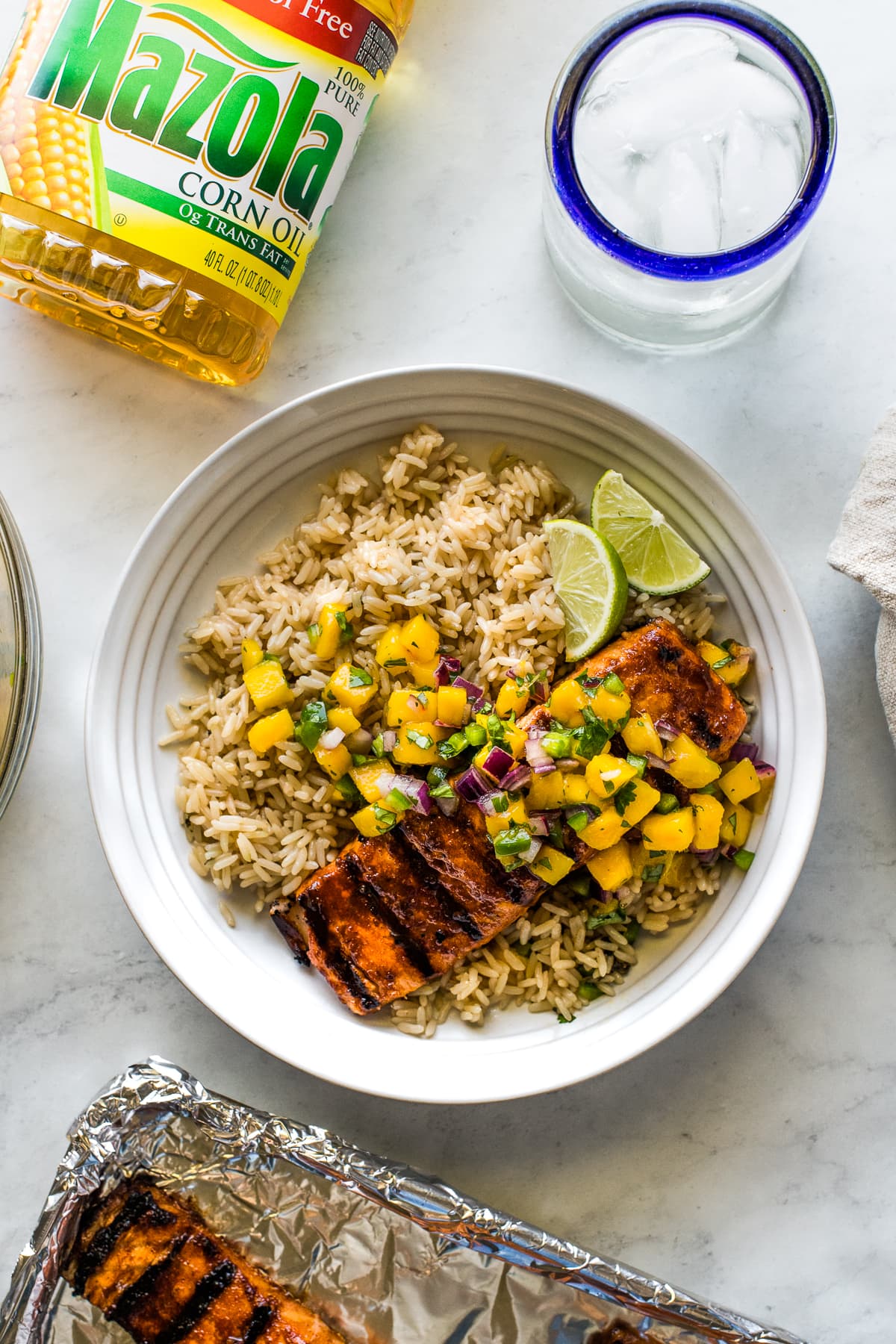 Grilled salmon served with rice and mango salsa.