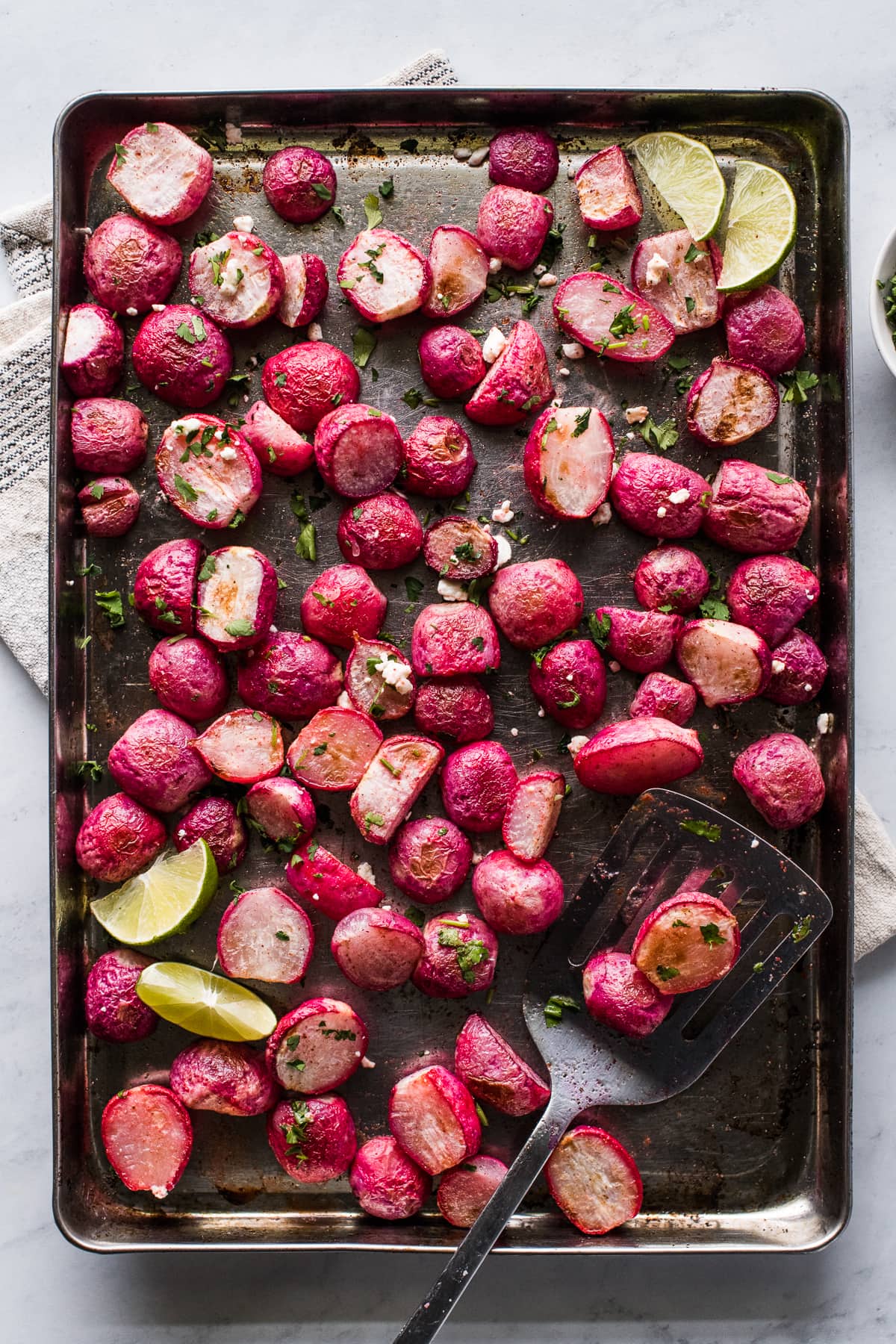 Roasted radishes on a sheet pan.