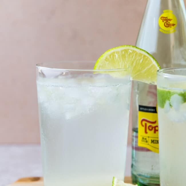 Ranch water drink in a tall glass garnished with a lime wedge.