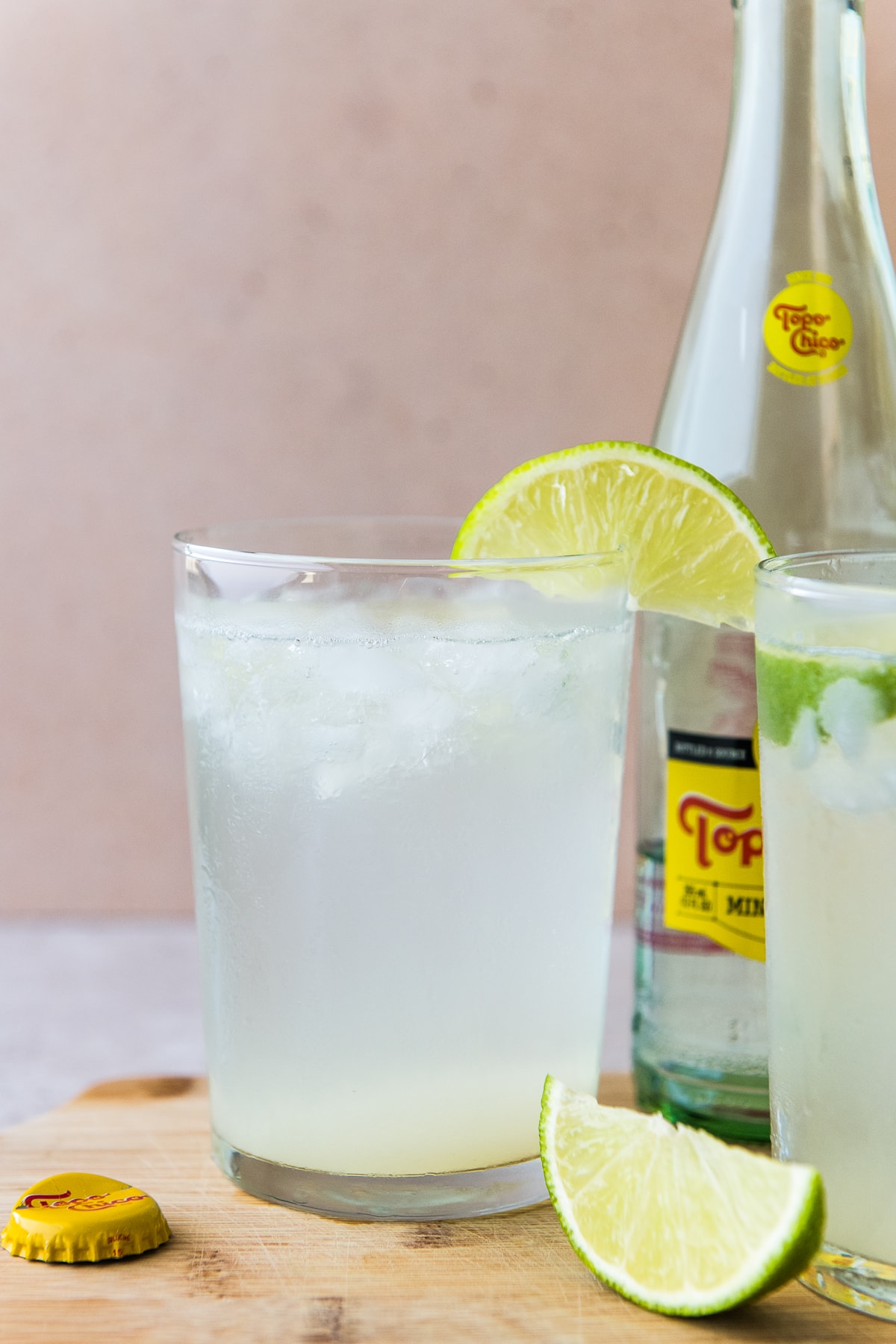 Ranch water drink in a tall glass garnished with a lime wedge.