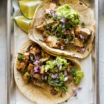 Easy chicken tacos recipe made with tender and juicy diced chicken and topped with avocado, onions, and lime juice.