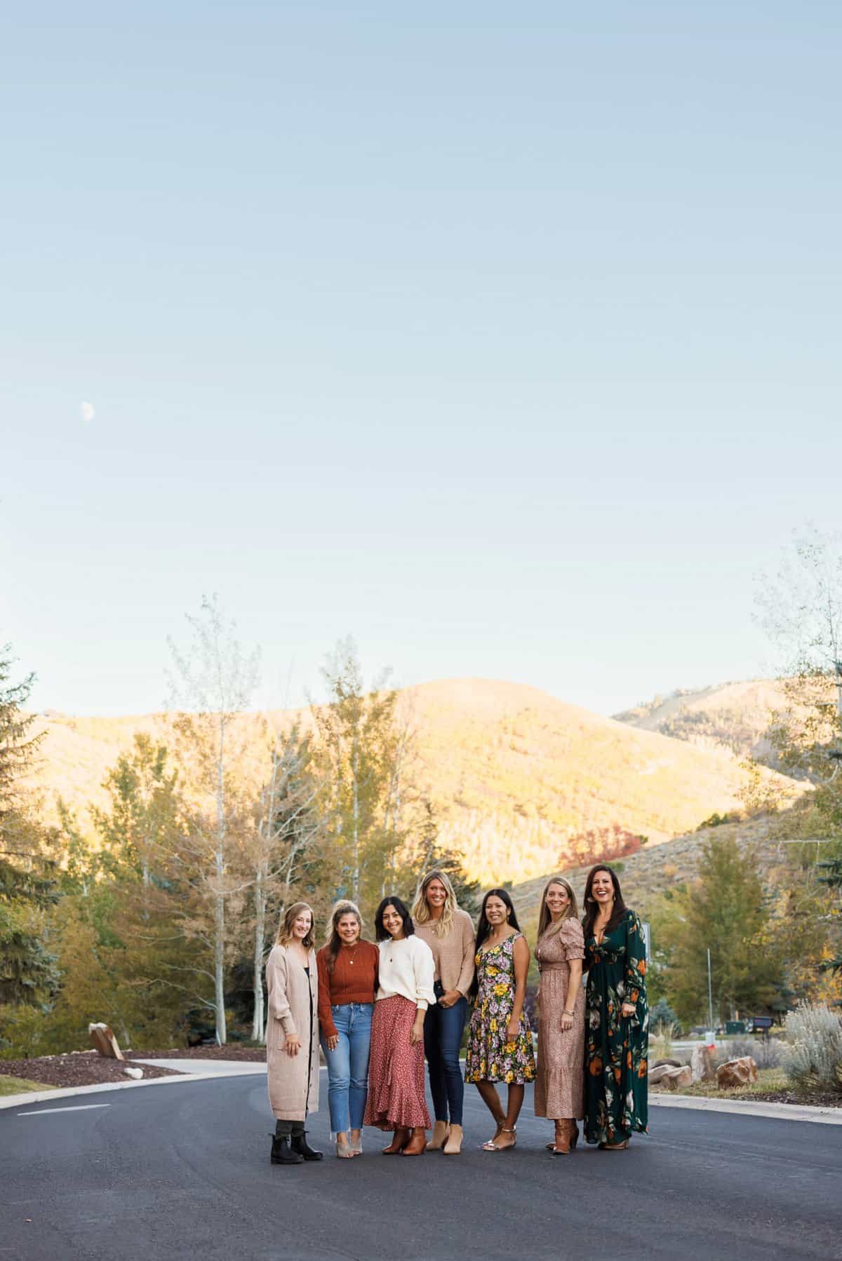 Attendees of the Fresh Air Retreat posing in front of the picturesque Rocky Mountains in Park City, Utah.