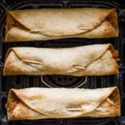 Crispy air fryer taquitos in an air fryer.