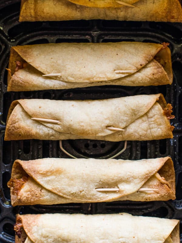 Crispy air fryer taquitos in an air fryer.