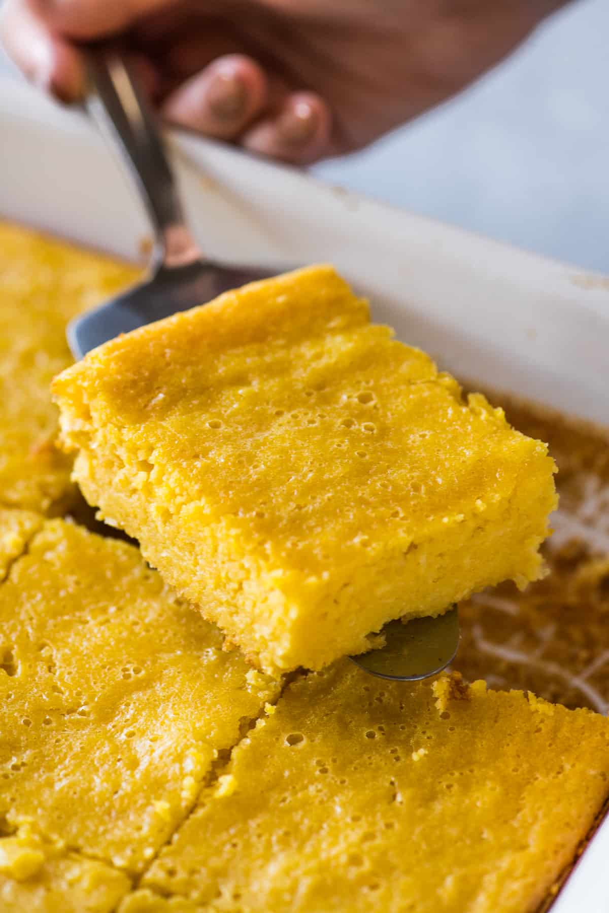 A slice of pan de elote on a cake server.