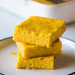 Pan de Elote stacked on top of one another on a plate.